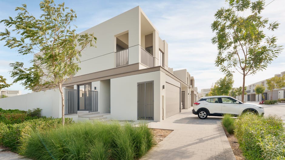 Modern residential property and luxury vehicle representing financial achievement